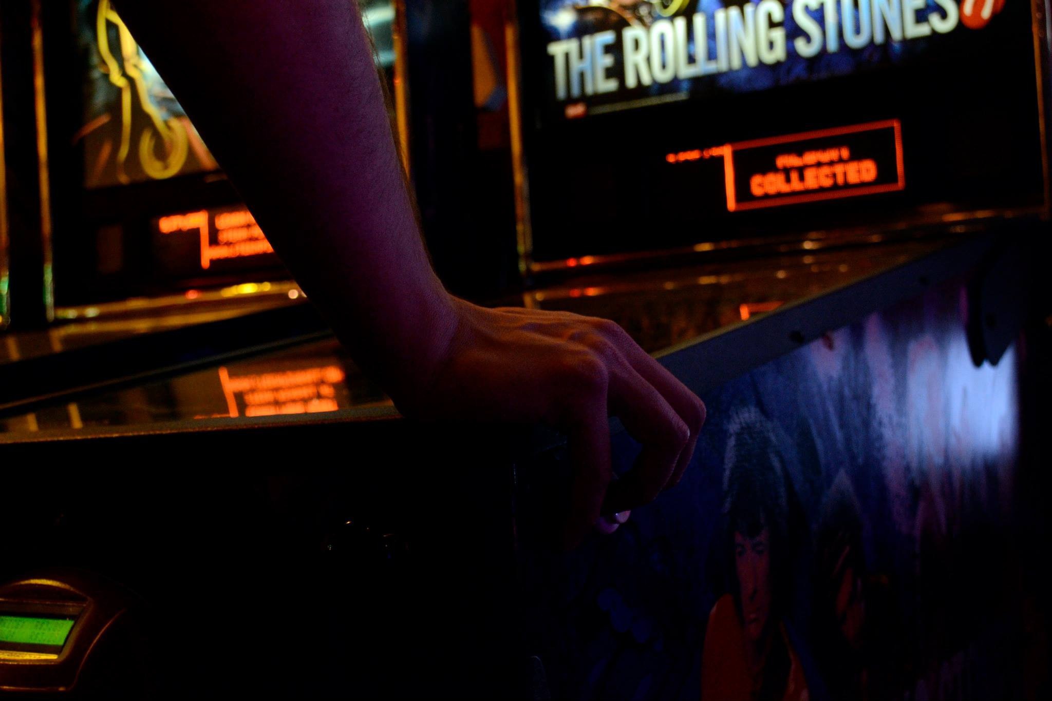 An image of a person playing an arcade game